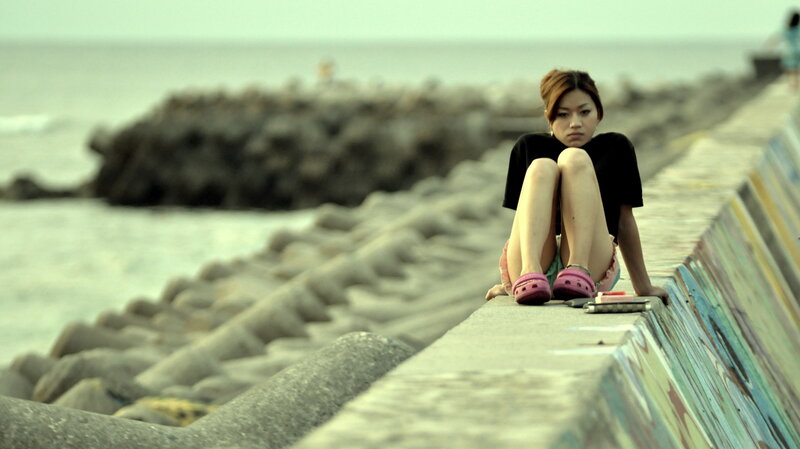 woman sitting on a seawall