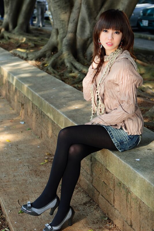 Woman sitting on a stone bench