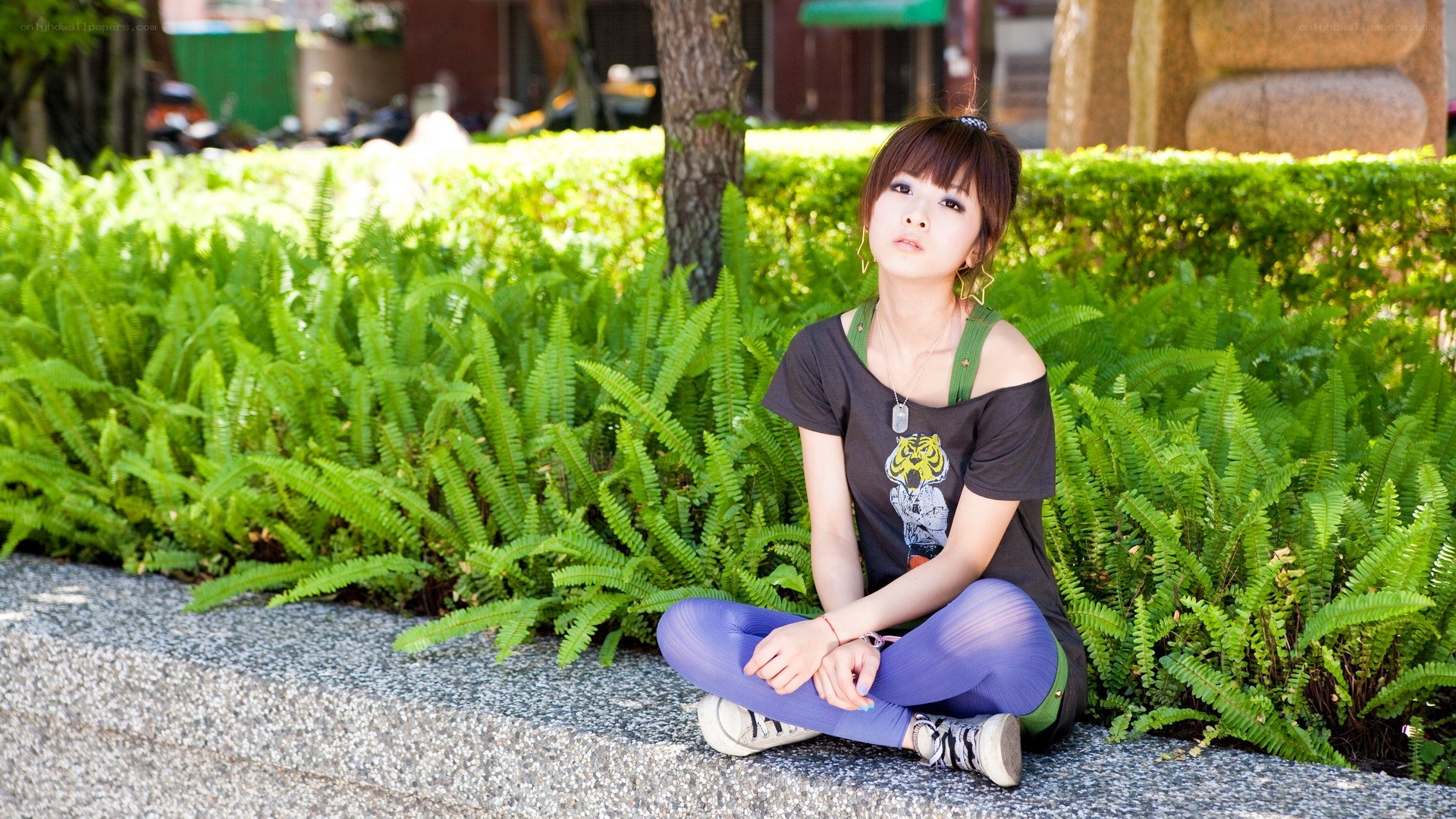 woman sitting on a stone ledge