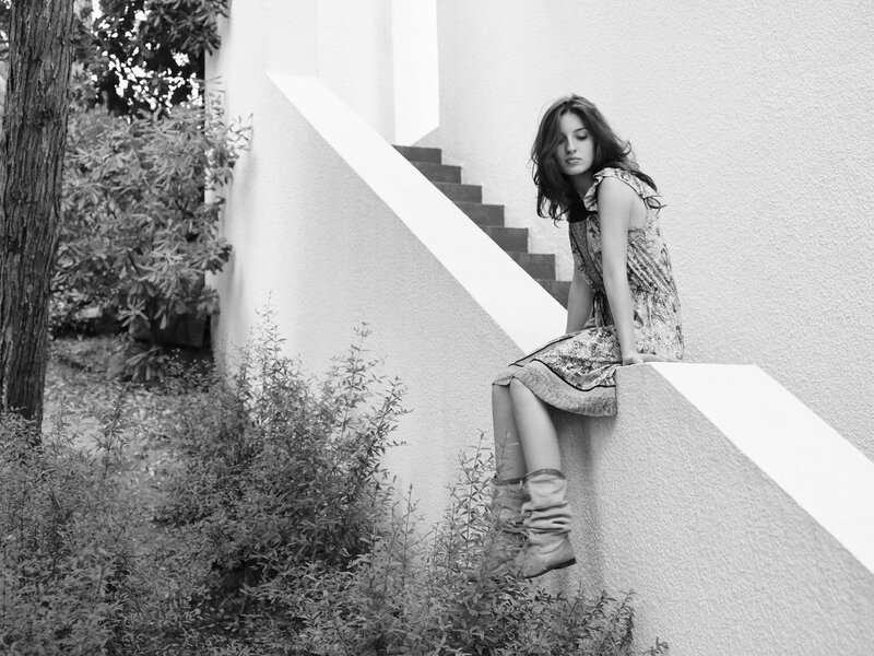 woman sitting on a wall
