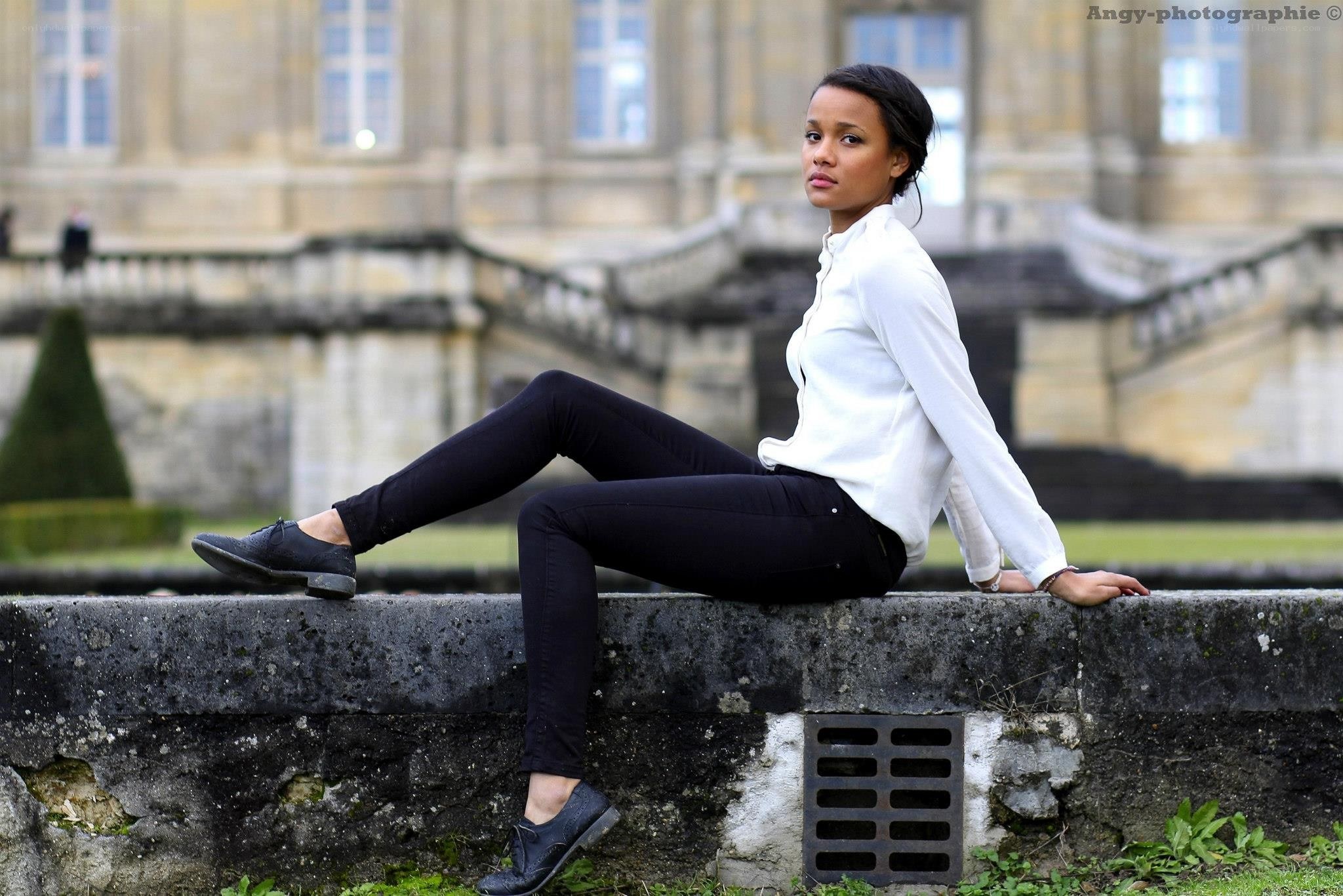 woman sitting on a wall