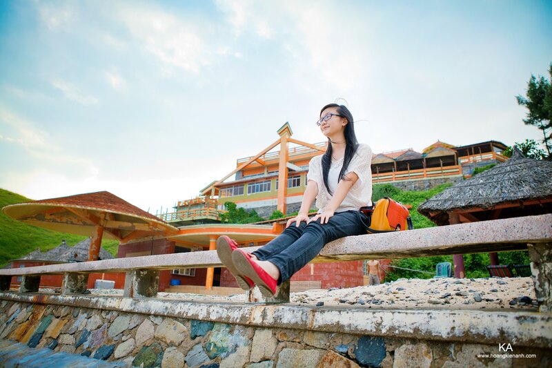 Woman sitting on a wall at a resort