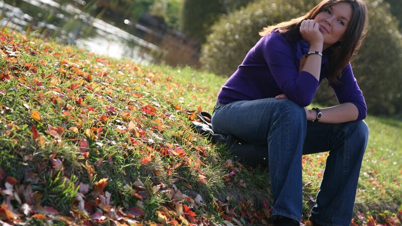 Woman sitting on autumn hillside