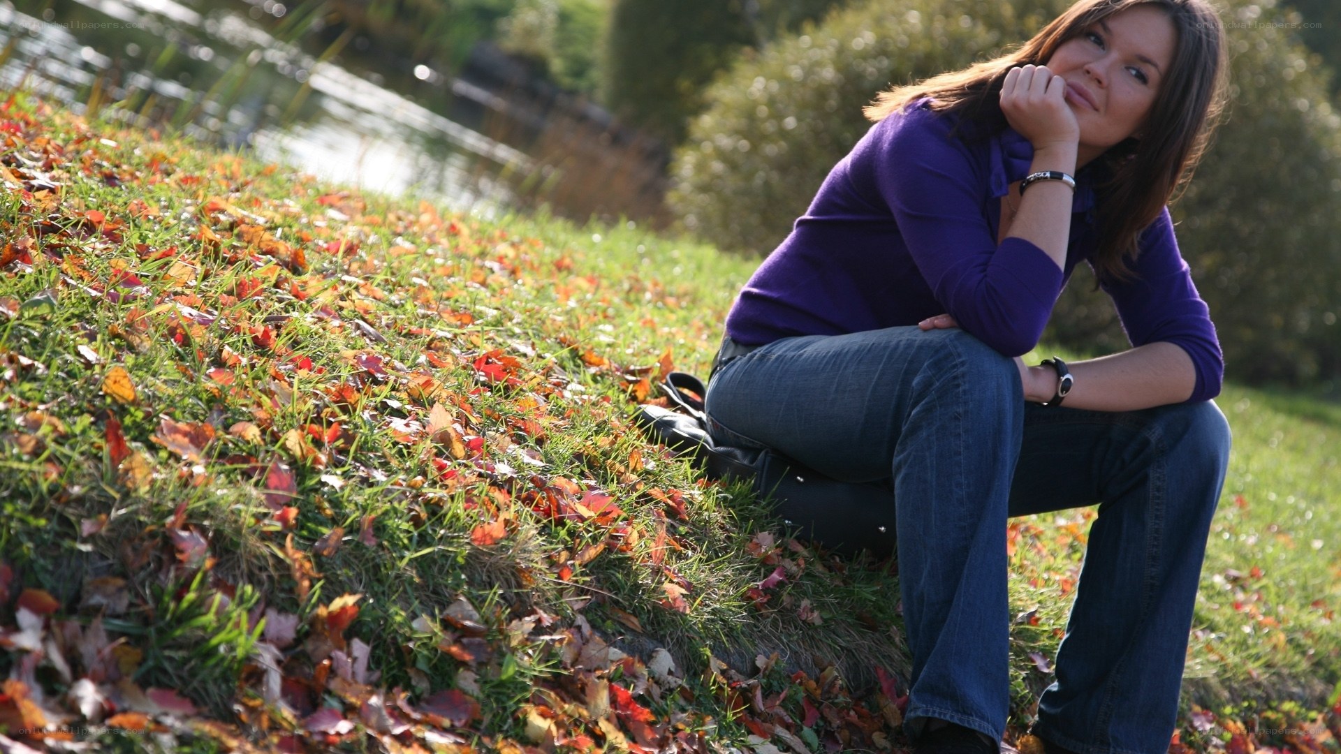 Woman sitting on autumn hillside
