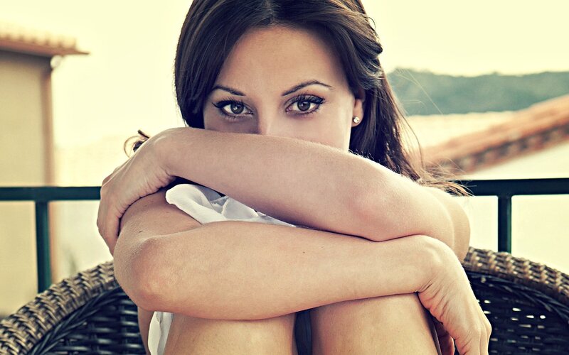 woman sitting on balcony