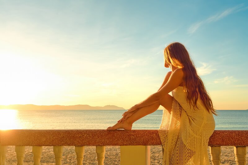 Woman Sitting on Balcony — Blue, Serene, Sunset