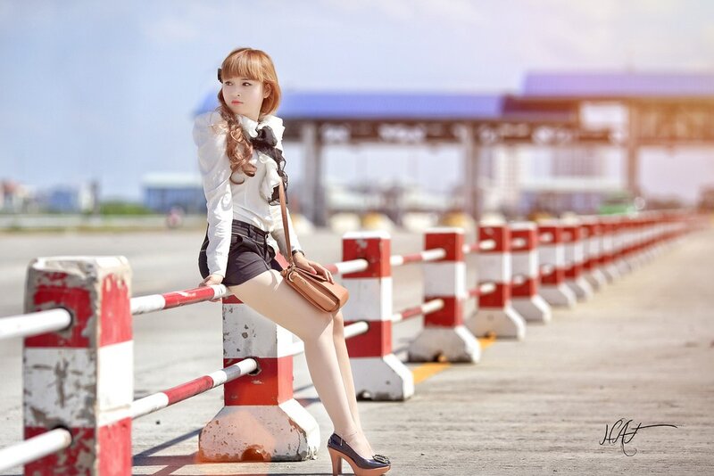 Woman Sitting on Barrier