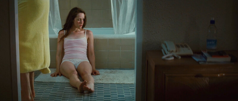 woman sitting on bathroom floor