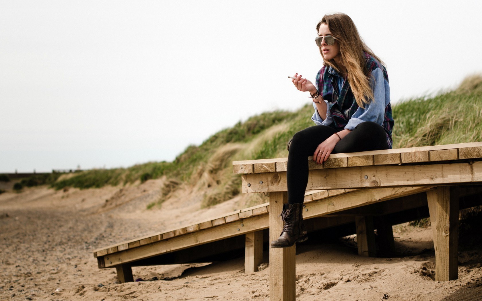 Woman sitting on beach bench