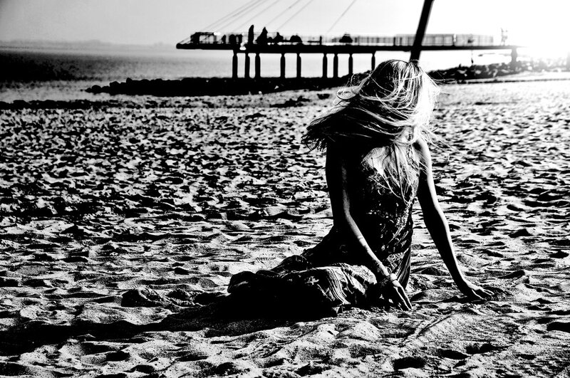 Woman Sitting on Beach — Black, Dramatic