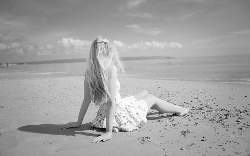 Woman Sitting on Beach — Black, Serene