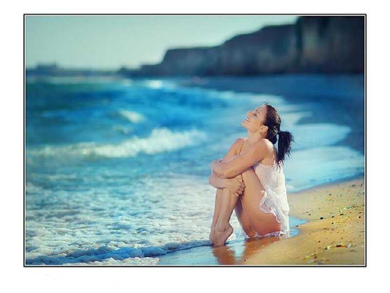 Woman Sitting on Beach — Blue, Serene, Afternoon, Photograph, Ocean, Sand, Cliffs