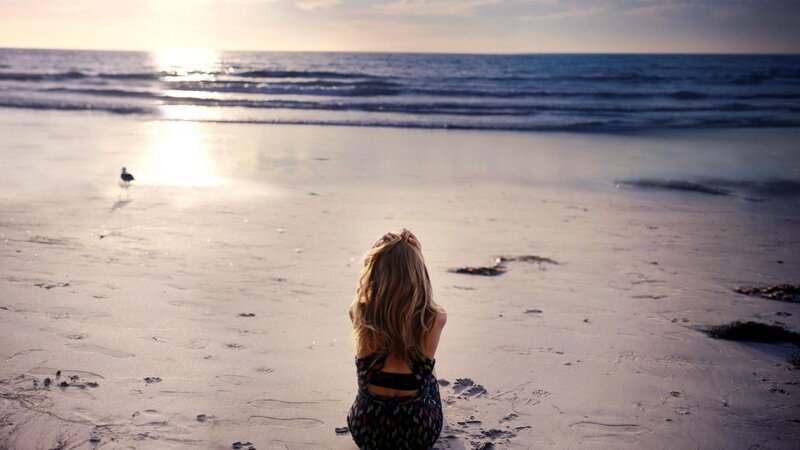 Woman Sitting on Beach — Blue, Serene, Sunset, Photograph