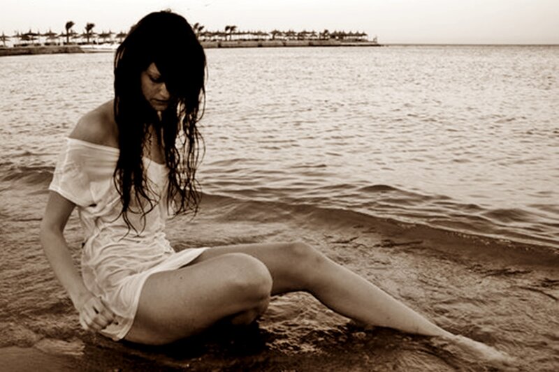 Woman Sitting on Beach — Brown, Melancholic