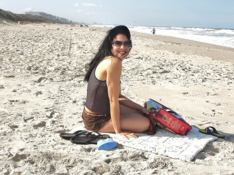 Woman Sitting on Beach — Brown