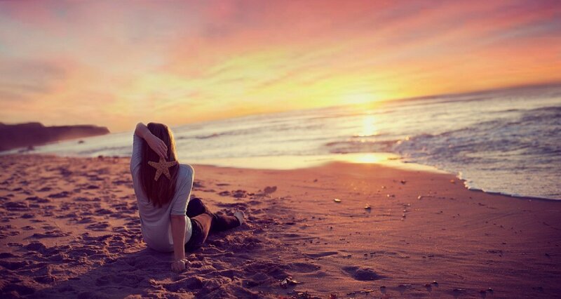 Woman Sitting on Beach — Pink, Serene, Sunset