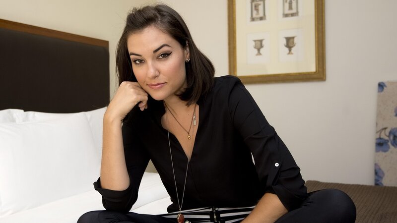 Woman Sitting on Bed — Black, Neutral, Photograph, Necklace