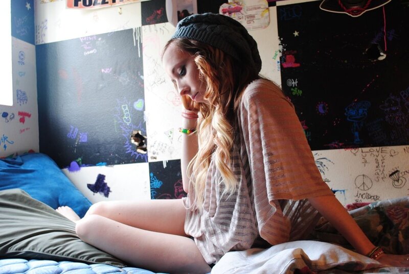 woman sitting on bed in bedroom