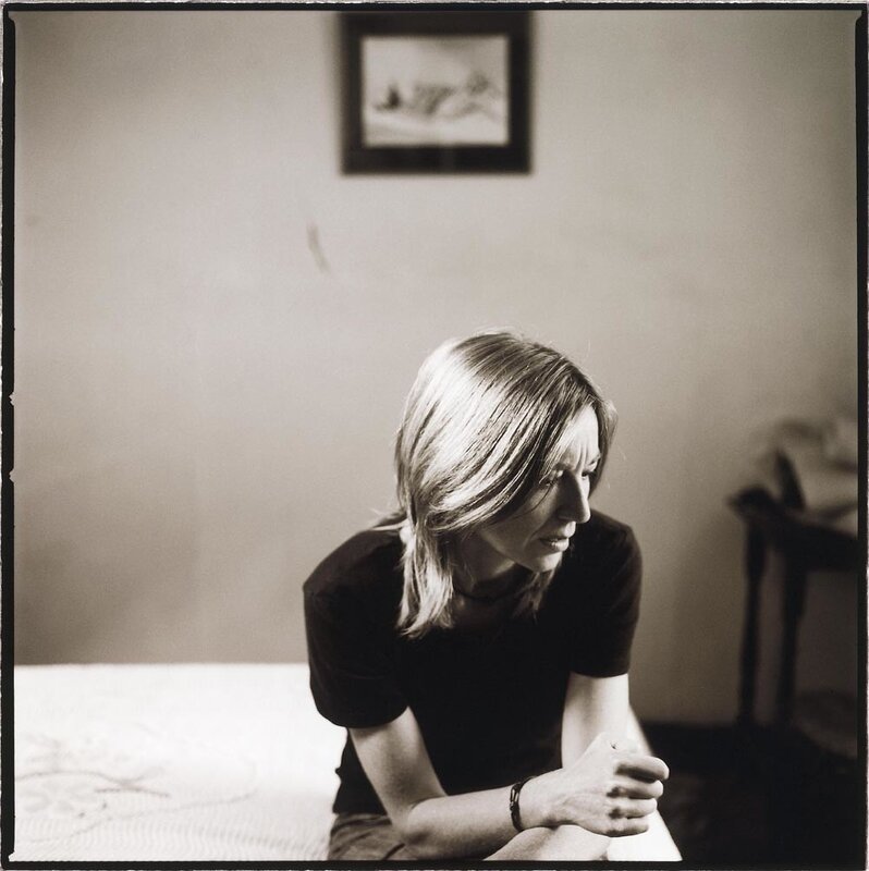 woman sitting on bed in contemplation