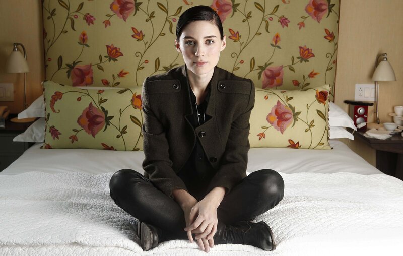 Woman Sitting on Bed — White, Neutral, Photograph, Pillows, Lamp
