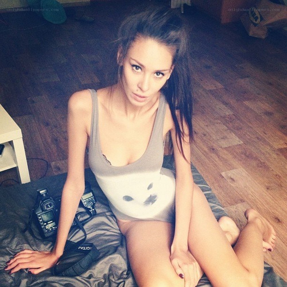 woman sitting on bed with camera