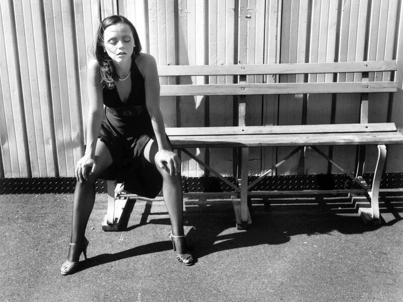 Woman Sitting on Bench — Black, Dramatic, Afternoon, Photograph, Corrugated Wall