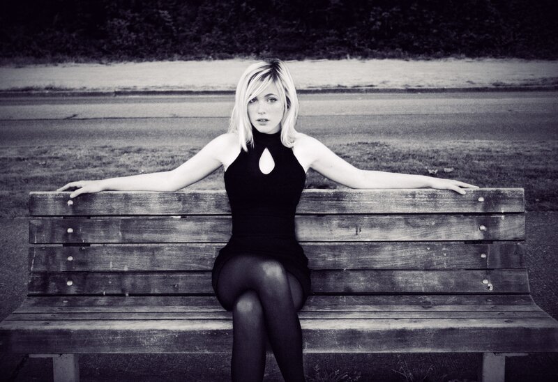 Woman Sitting on Bench — Black, Dramatic, Photograph, Grass
