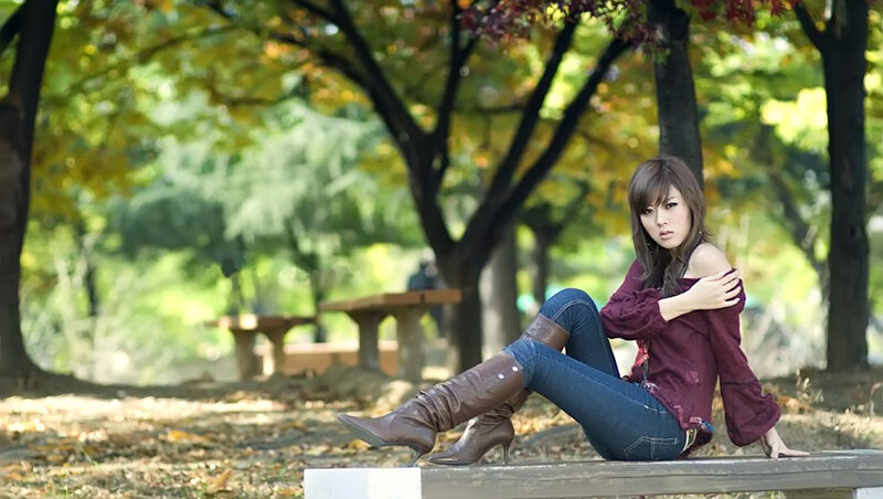 Woman Sitting on Bench — Brown