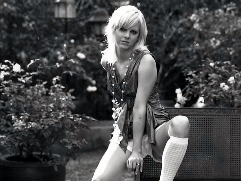 woman sitting on bench in garden