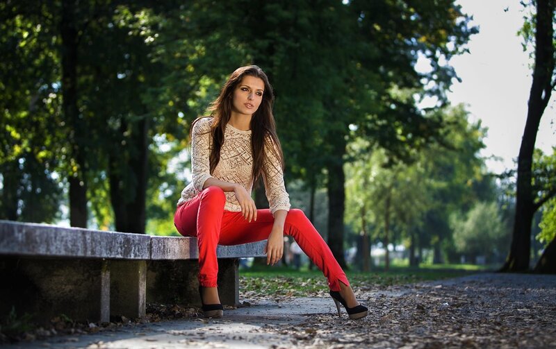 woman sitting on bench in park