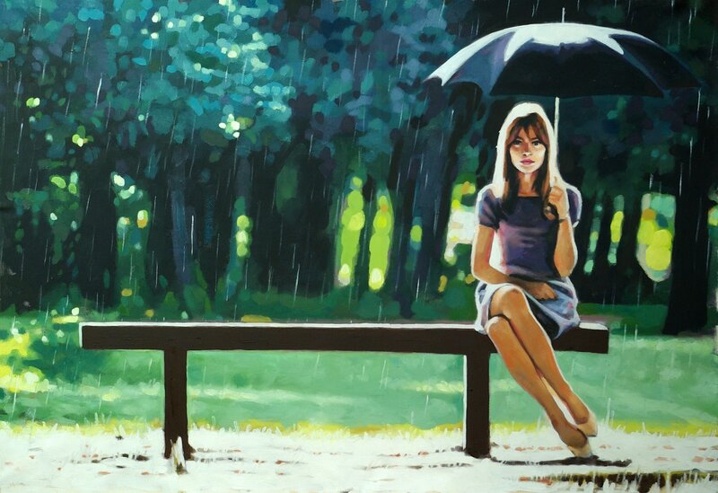 Woman sitting on bench in rain