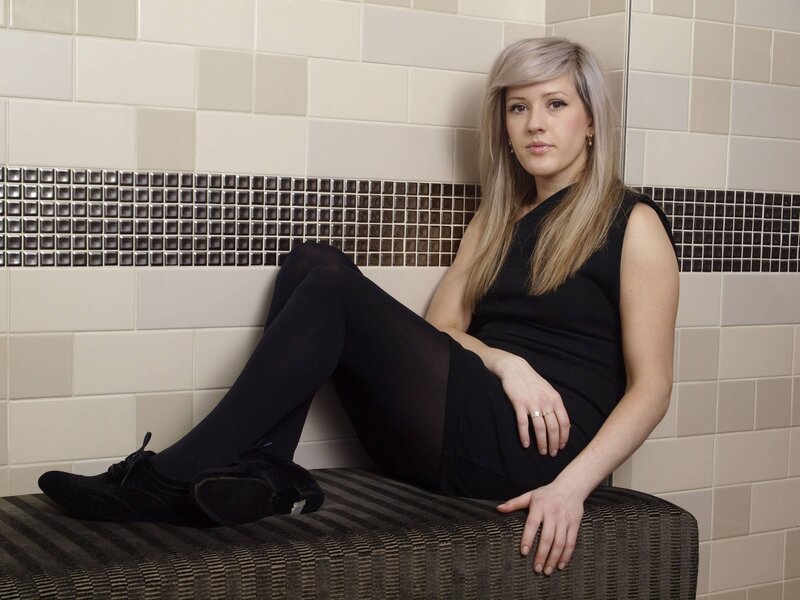 woman sitting on bench in tiled room