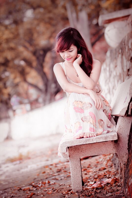 woman sitting on bench outdoors