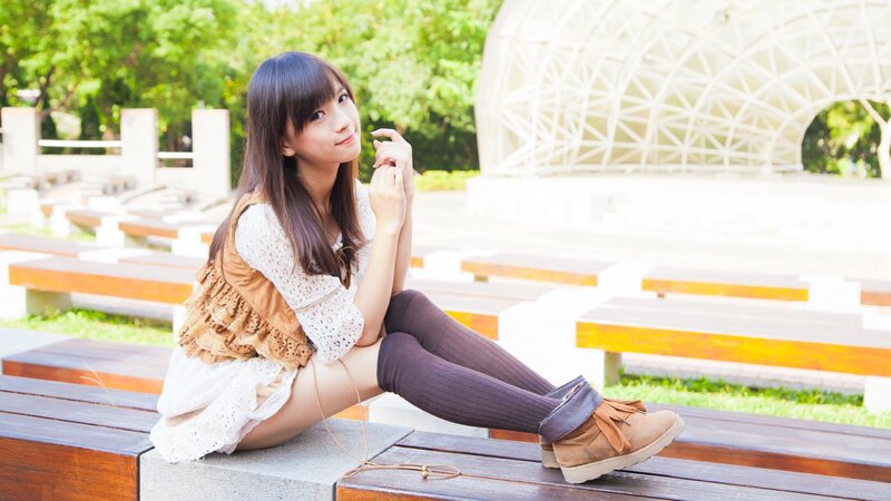 woman sitting on bench outdoors