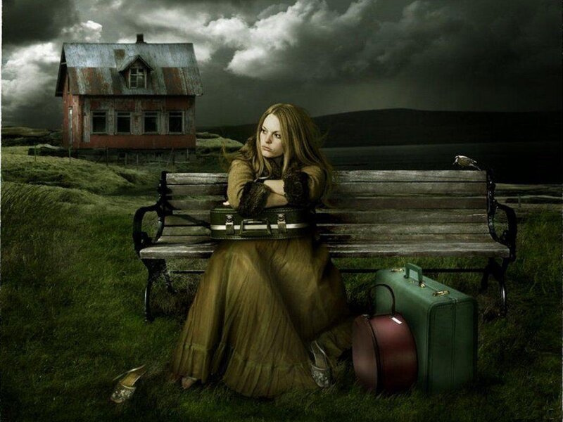 woman sitting on bench with suitcases