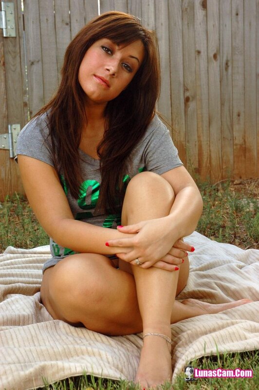 woman sitting on blanket outdoors