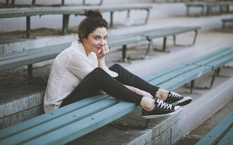 woman sitting on bleachers