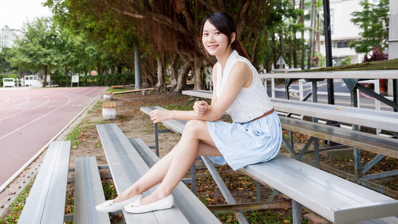 Woman sitting on bleachers