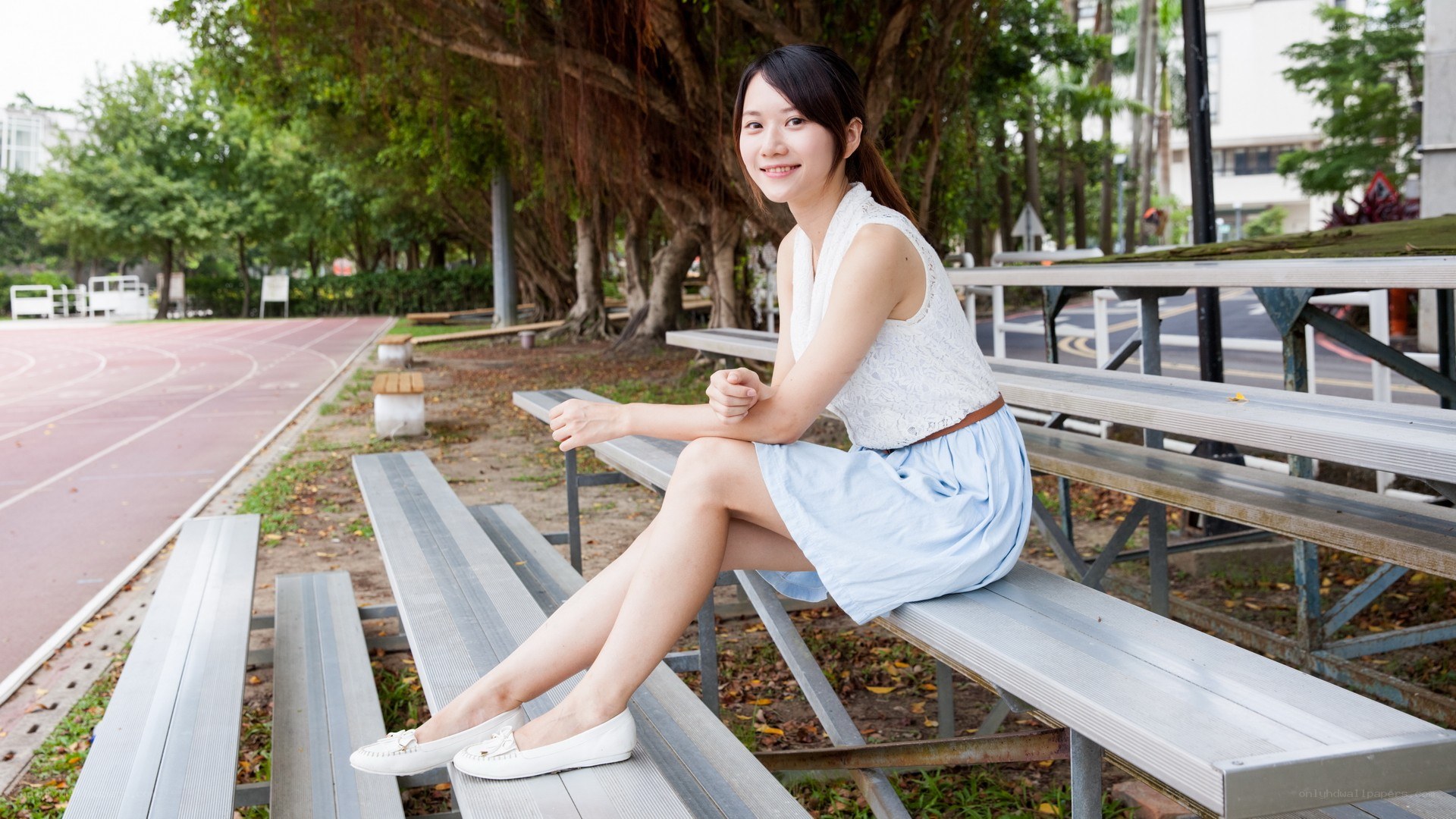 Woman sitting on bleachers