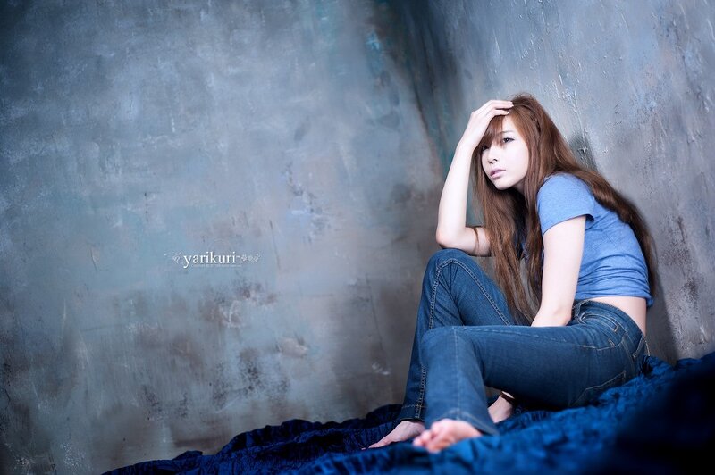 woman sitting on blue fabric