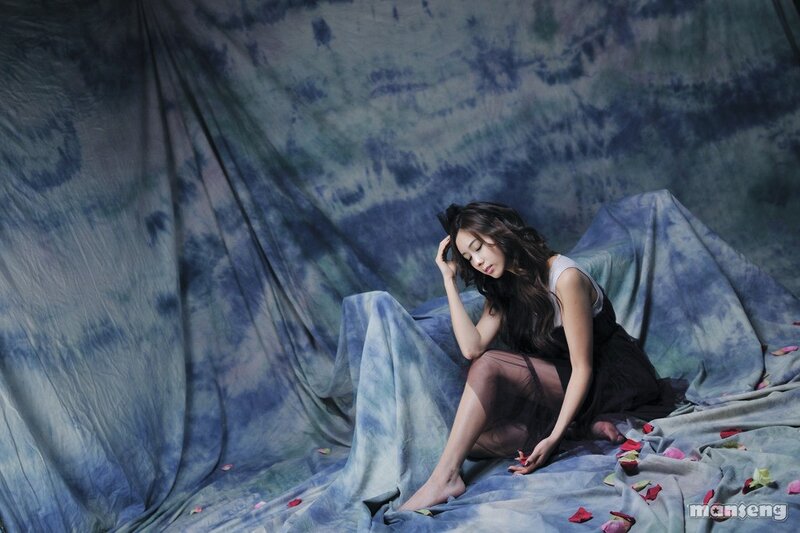 woman sitting on blue fabric