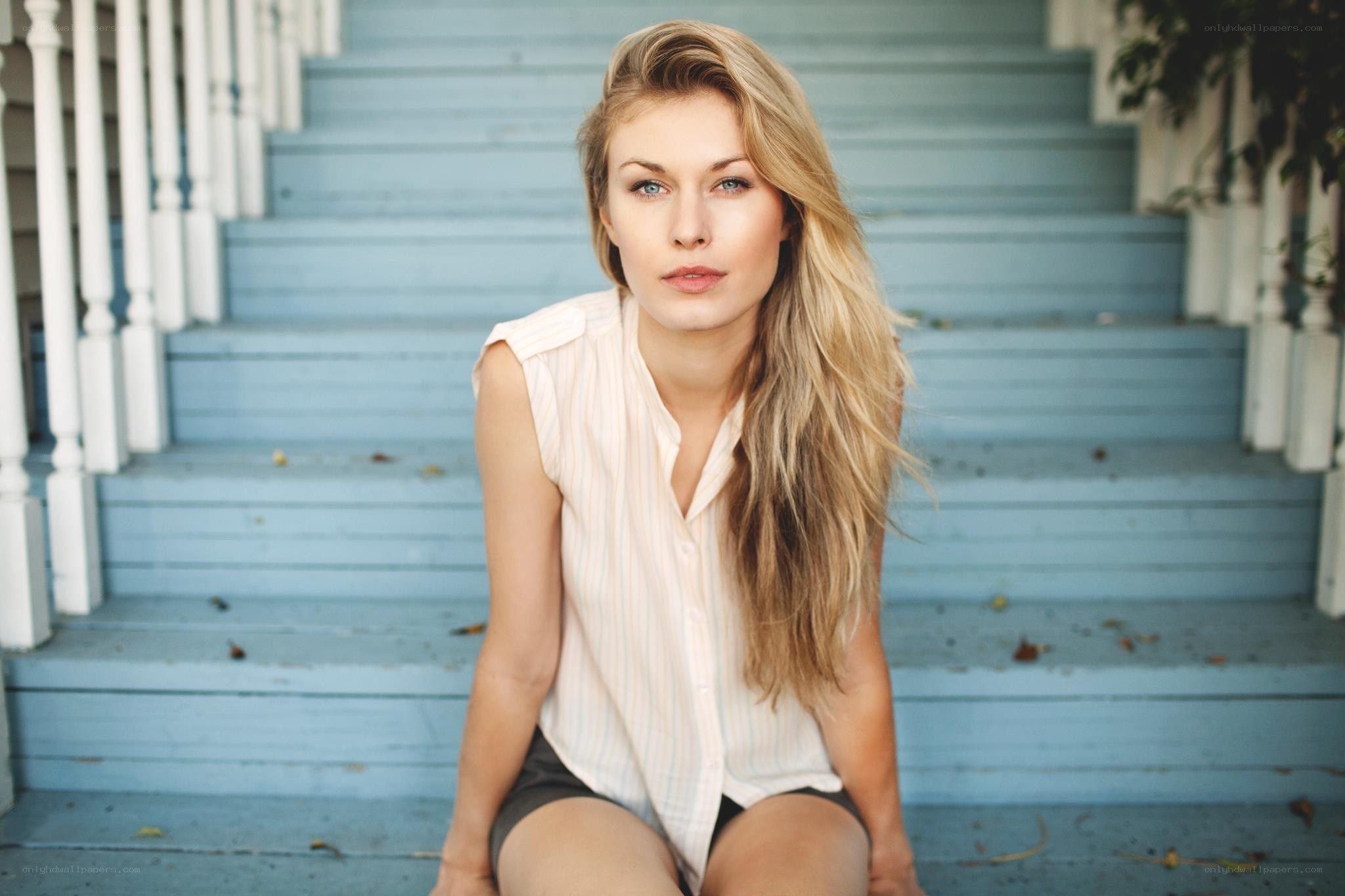 woman sitting on blue steps