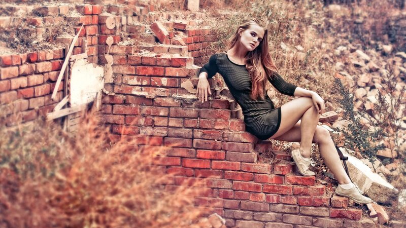 woman sitting on brick ruins