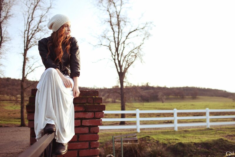 woman sitting on brick wall