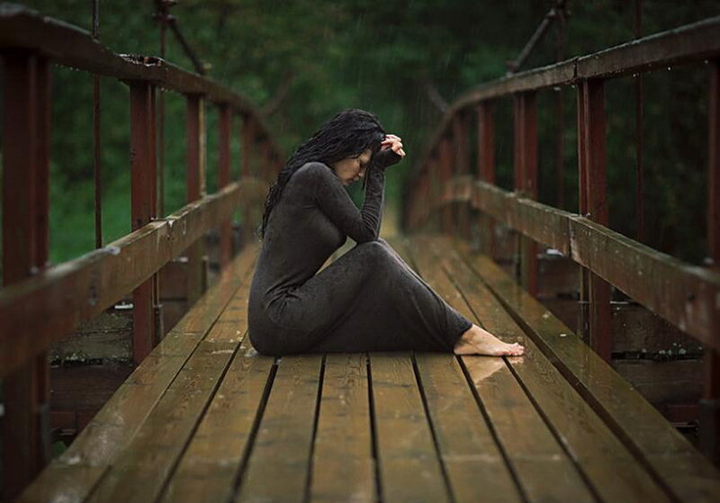 Woman Sitting on Bridge — Brown