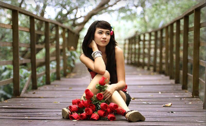 Woman Sitting on Bridge — Red