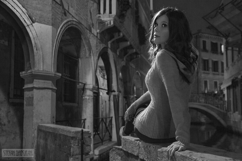 woman sitting on canal wall