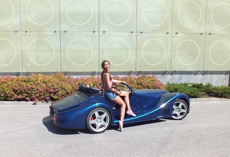 Woman Sitting on Car — Blue, Relaxed