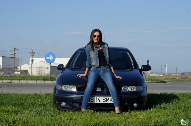 woman sitting on car hood