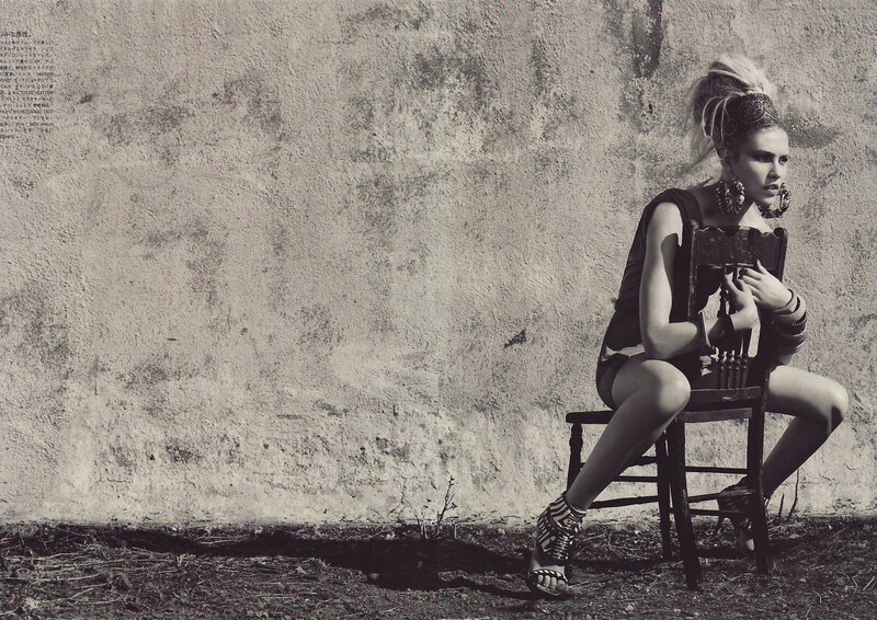 woman sitting on chair against wall